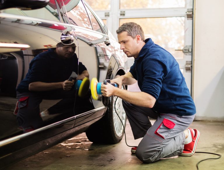 Silver car being buffed out after minor dents or scratches, returning the car to new without paint.